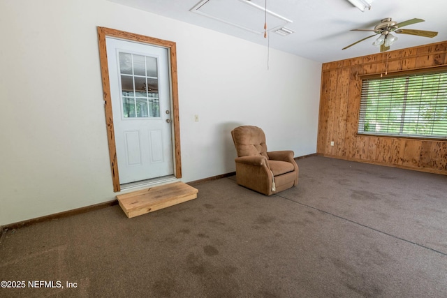 unfurnished room with attic access, baseboards, and carpet floors