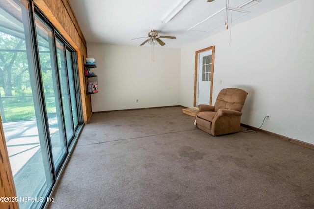 unfurnished room featuring attic access, ceiling fan, carpet, and baseboards