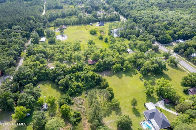 birds eye view of property featuring a rural view and a view of trees