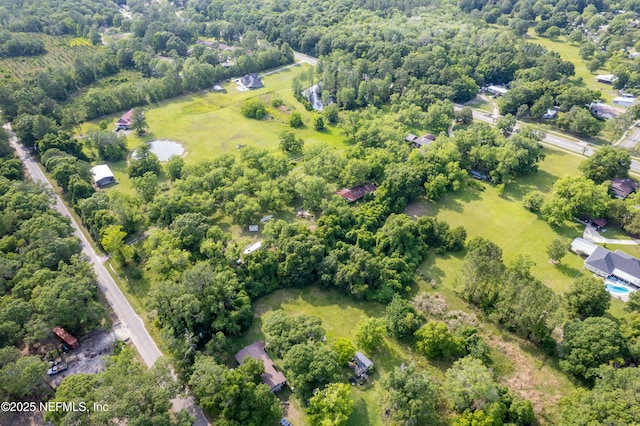 birds eye view of property featuring a wooded view
