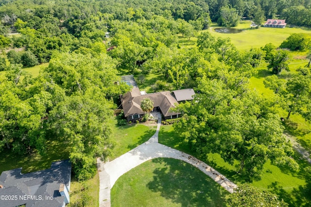 bird's eye view featuring a wooded view
