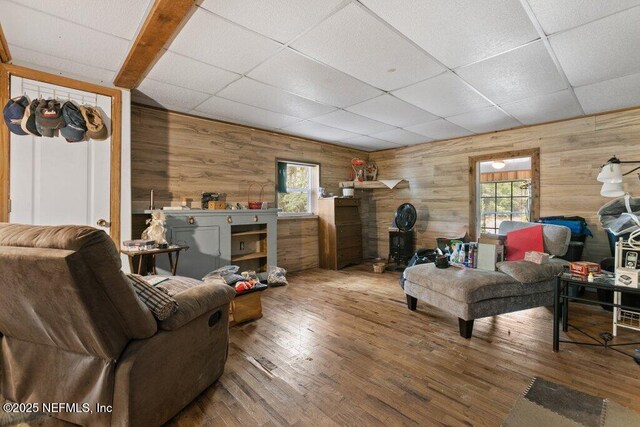 670 Hillsborough Ave, Florahome, FL 32140 - living room featuring wooden walls, a drop ceiling, and wood finished floors