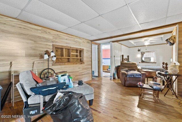 670 Hillsborough Ave, Florahome, FL 32140 - living area with wood walls, wood-type flooring, and a drop ceiling
