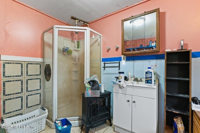 670 Hillsborough Ave, Florahome, FL 32140 - full bath with tile walls, a stall shower, a wainscoted wall, and vanity