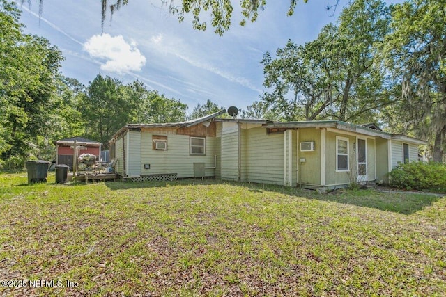 670 Hillsborough Ave, Florahome, FL 32140 - back of property with a lawn and a wall mounted AC