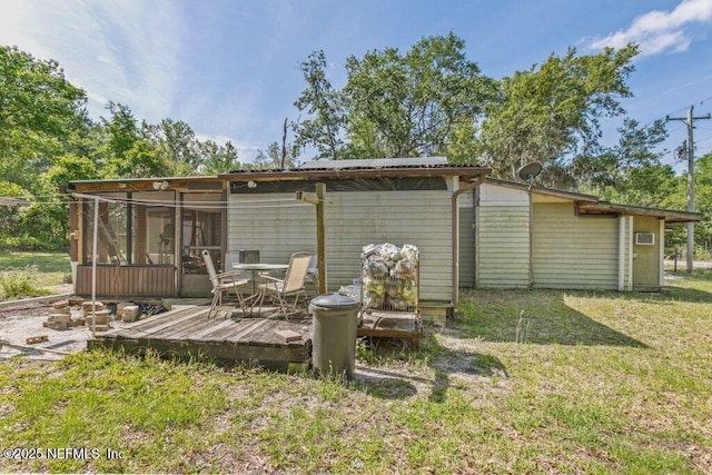 670 Hillsborough Ave, Florahome, FL 32140 - rear view of house with a deck, a yard, and a sunroom