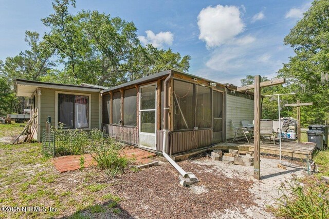 670 Hillsborough Ave, Florahome, FL 32140 - view of home's exterior with a sunroom