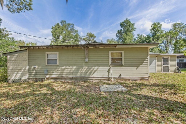 670 Hillsborough Ave, Florahome, FL 32140 - rear view of house featuring a lawn