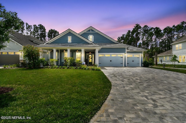 225 Shinnecock Dr, Saint Johns, FL 32259 - craftsman-style home featuring a garage, covered porch, a lawn, and decorative driveway