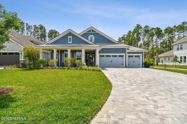 225 Shinnecock Dr, Saint Johns, FL 32259 - craftsman-style house featuring a garage, a porch, a front lawn, and decorative driveway