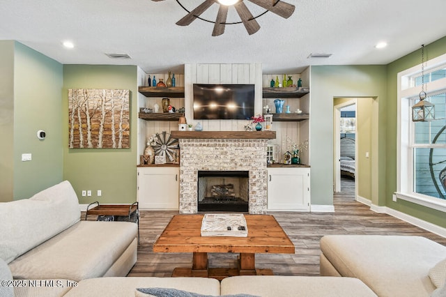 225 Shinnecock Dr, Saint Johns, FL 32259 - living area with wood finished floors, visible vents, a ceiling fan, baseboards, and a brick fireplace