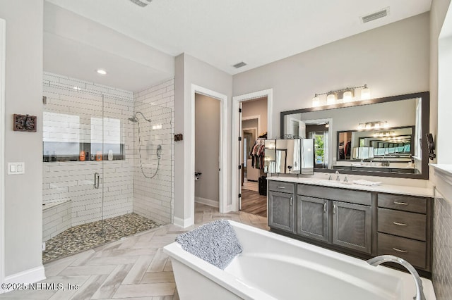 225 Shinnecock Dr, Saint Johns, FL 32259 - bathroom with a freestanding tub, vanity, a stall shower, and visible vents