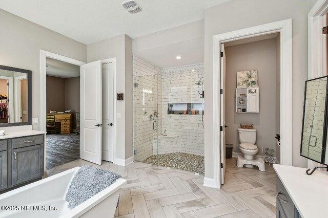 225 Shinnecock Dr, Saint Johns, FL 32259 - bathroom with toilet, a stall shower, vanity, baseboards, and visible vents
