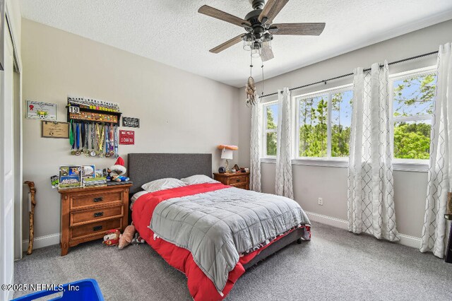 225 Shinnecock Dr, Saint Johns, FL 32259 - carpeted bedroom featuring ceiling fan, baseboards, and a textured ceiling