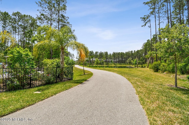 225 Shinnecock Dr, Saint Johns, FL 32259 - view of home's community featuring fence, driveway, a yard, and a wooded view
