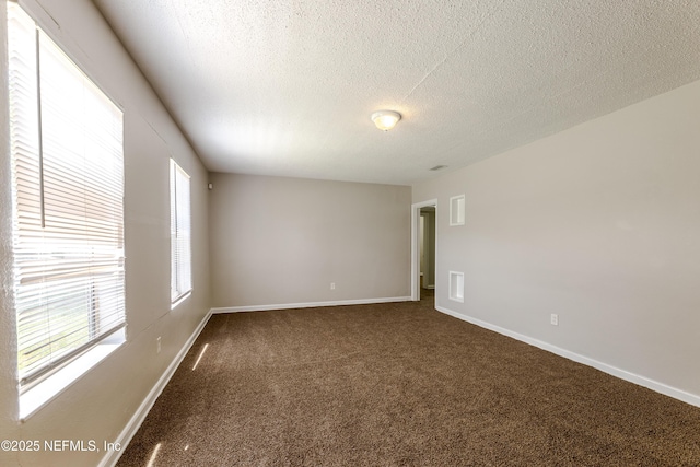 8344 Delaware Ave, Jacksonville, FL 32208 - unfurnished room featuring dark carpet, baseboards, and a textured ceiling