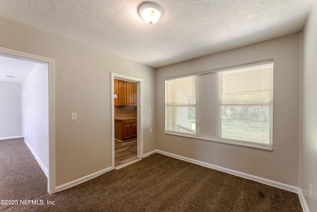 8344 Delaware Ave, Jacksonville, FL 32208 - empty room featuring visible vents, baseboards, dark carpet, and a textured ceiling