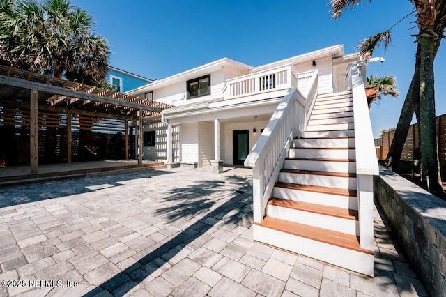 2818 Coastal Hwy, Saint Augustine, FL 32084 - rear view of house with a pergola, stairs, and a patio area