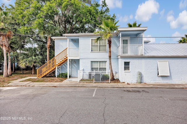 3434 Blanding Blvd Unit 214, Jacksonville, FL 32210 - view of front of home with brick siding, fence, a balcony, and stairway