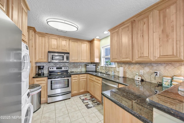 3434 Blanding Blvd Unit 214, Jacksonville, FL 32210 - kitchen with a sink, a textured ceiling, dark stone counters, appliances with stainless steel finishes, and light tile patterned floors