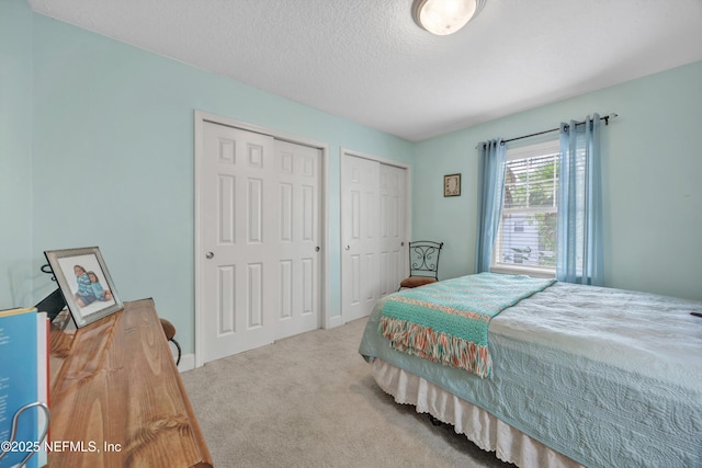 3434 Blanding Blvd Unit 214, Jacksonville, FL 32210 - bedroom with multiple closets, carpet flooring, and a textured ceiling
