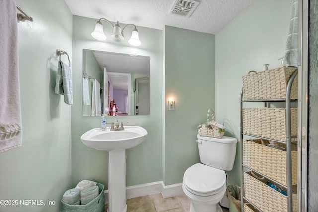 3434 Blanding Blvd Unit 214, Jacksonville, FL 32210 - half bathroom with tile patterned floors, a textured ceiling, toilet, baseboards, and visible vents