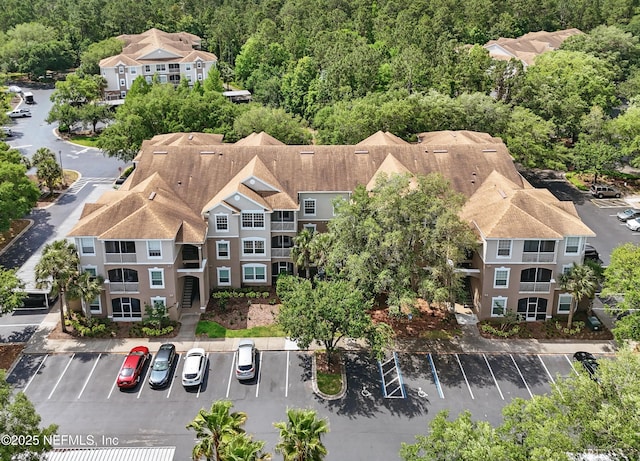 birds eye view of property with a forest view
