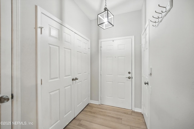 doorway to outside featuring light wood-style floors and baseboards