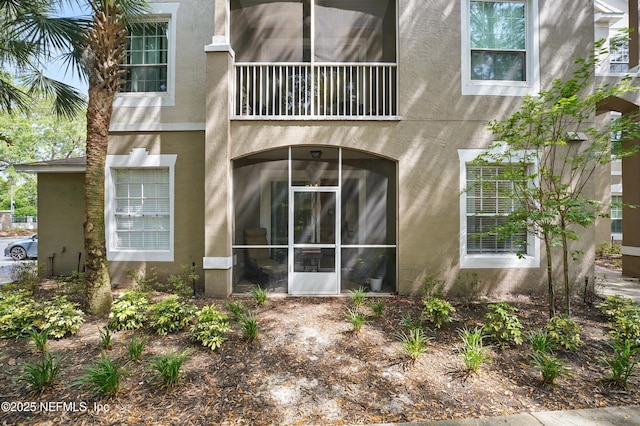 back of property featuring stucco siding