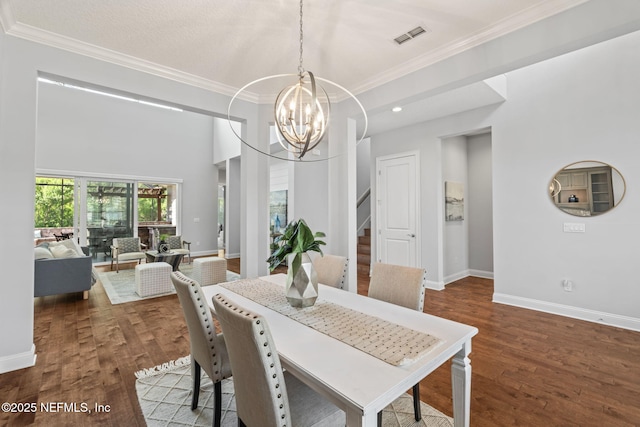 dining area featuring baseboards, stairs, an inviting chandelier, and crown molding