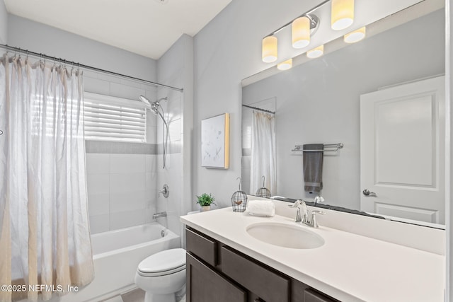 bathroom with toilet, vanity, and shower / bath combination with curtain