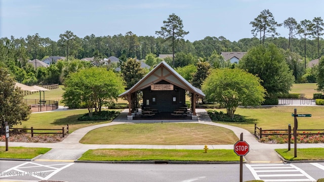 surrounding community featuring fence and a lawn