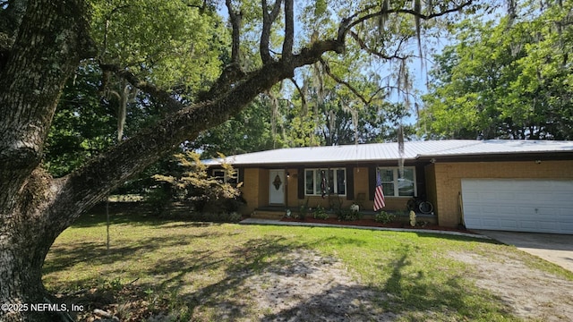 45116 Coquina Way, Callahan, FL 32011 - view of front of property with an attached garage, concrete driveway, a front lawn, and metal roof