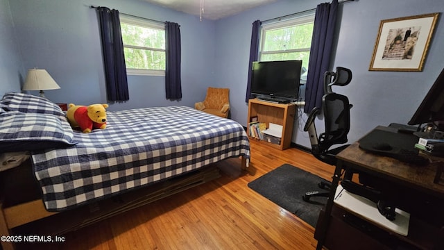 45116 Coquina Way, Callahan, FL 32011 - bedroom featuring light wood finished floors, multiple windows, and a desk