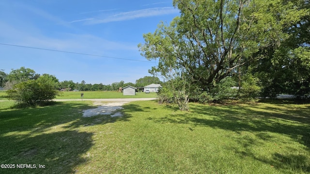 45116 Coquina Way, Callahan, FL 32011 - view of green lawn featuring an outdoor structure