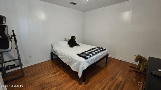 45116 Coquina Way, Callahan, FL 32011 - bedroom featuring baseboards and wood finished floors