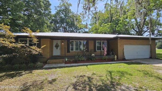 45116 Coquina Way, Callahan, FL 32011 - ranch-style home featuring driveway, a garage, a front yard, and metal roof