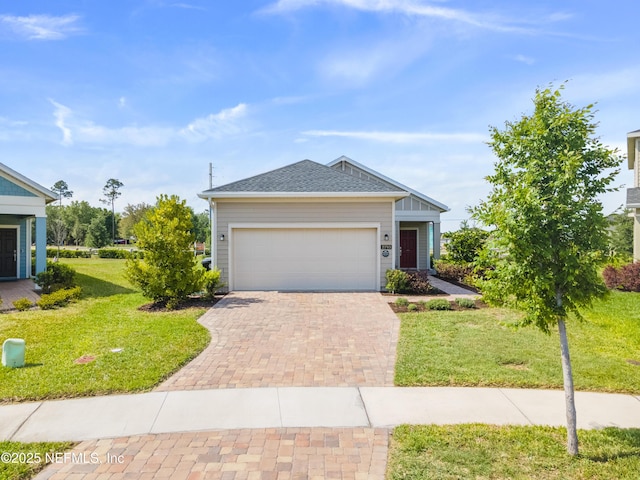 2793 Pointed Leaf Rd, Green Cove Springs, FL 32043 - single story home featuring an attached garage, roof with shingles, a front yard, and decorative driveway