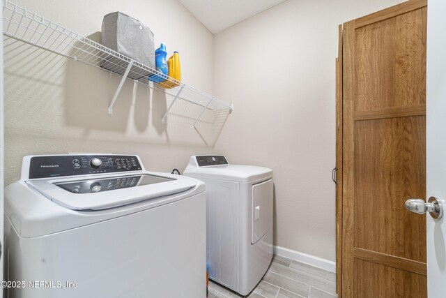 2793 Pointed Leaf Rd, Green Cove Springs, FL 32043 - laundry room with light wood-style flooring, baseboards, independent washer and dryer, and laundry area