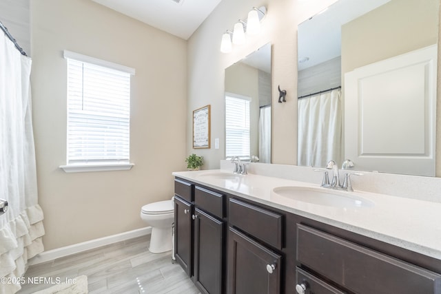 2793 Pointed Leaf Rd, Green Cove Springs, FL 32043 - bathroom featuring toilet, a sink, double vanity, and baseboards