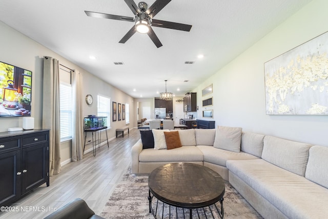 2793 Pointed Leaf Rd, Green Cove Springs, FL 32043 - living area with recessed lighting, visible vents, light wood-style floors, baseboards, and ceiling fan with notable chandelier