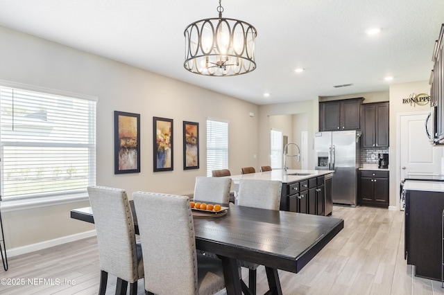 2793 Pointed Leaf Rd, Green Cove Springs, FL 32043 - dining area with a wealth of natural light, a chandelier, and light wood-style floors