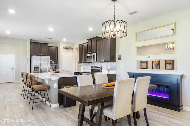 2793 Pointed Leaf Rd, Green Cove Springs, FL 32043 - dining space with a chandelier, visible vents, light wood finished floors, and baseboards