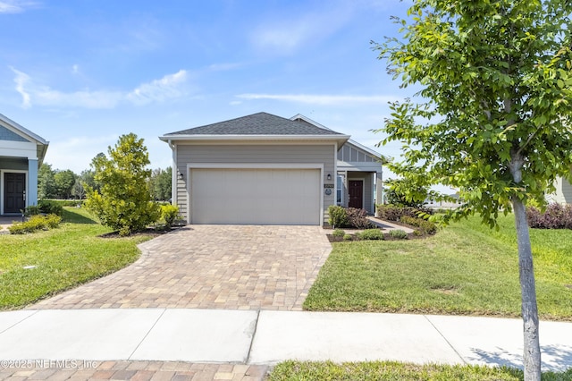 2793 Pointed Leaf Rd, Green Cove Springs, FL 32043 - ranch-style house with a garage, a shingled roof, a front lawn, and decorative driveway