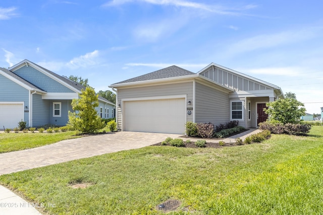 2793 Pointed Leaf Rd, Green Cove Springs, FL 32043 - single story home featuring board and batten siding, an attached garage, a front yard, and decorative driveway