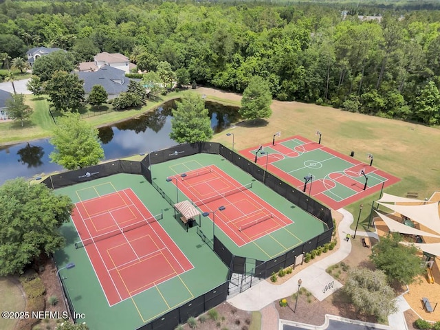 aerial view featuring a water view and a wooded view