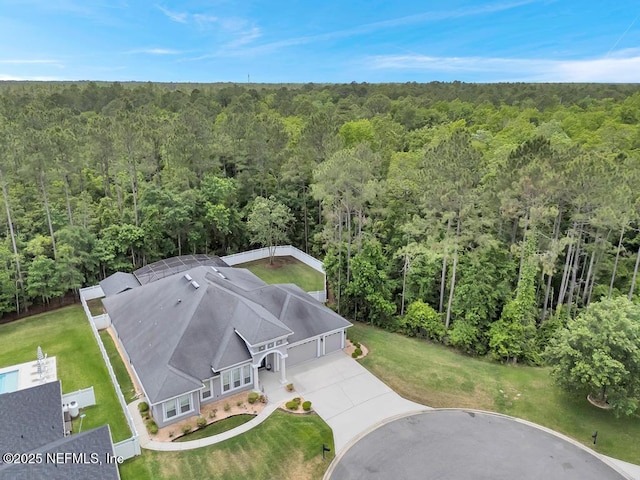 drone / aerial view with a wooded view