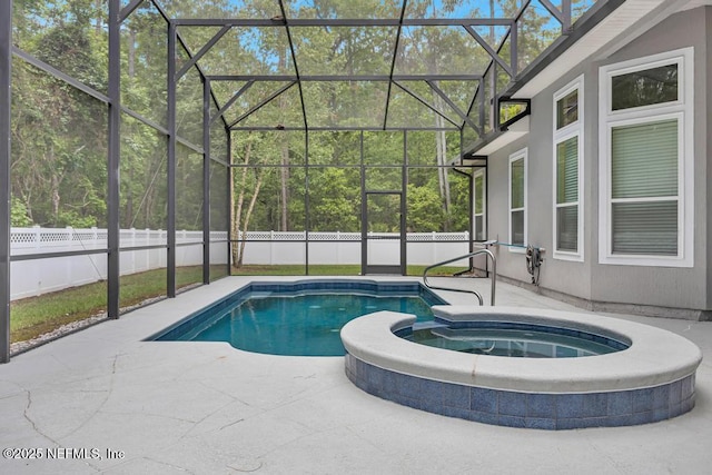 view of swimming pool featuring a fenced backyard, a patio, and glass enclosure