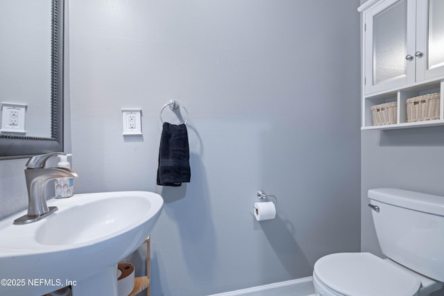 half bath with a sink and toilet