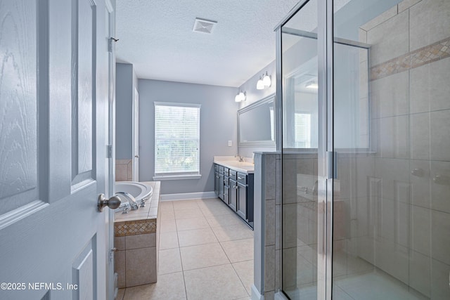 full bathroom featuring vanity, a stall shower, tile patterned floors, and visible vents